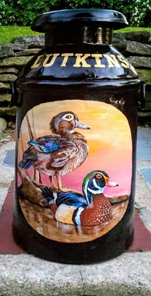 A pair of wood ducks painted in warm sunset tones
